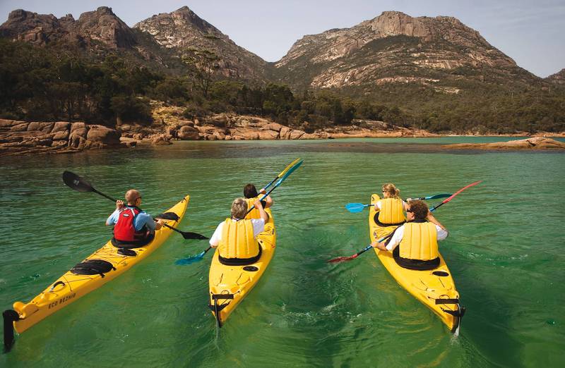 Kayaking the crystal clear waters of the Freycinet Peninsula on Cycle, Kayak and Walk Tasmania
