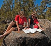 Enjoying the sunshine, reading maps on a Tasmanian Expeditions trek |  <i>Don Fuchs</i>